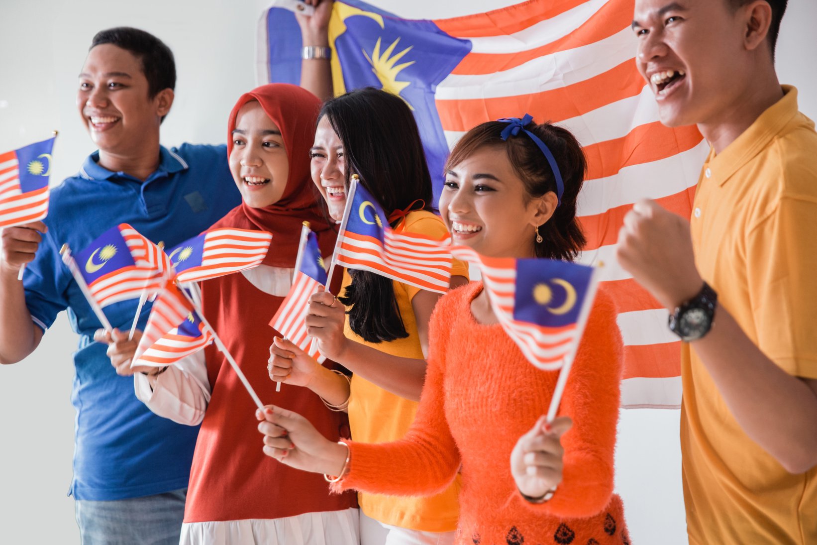 People Holding Malaysia Flag Celebrating Independence Day